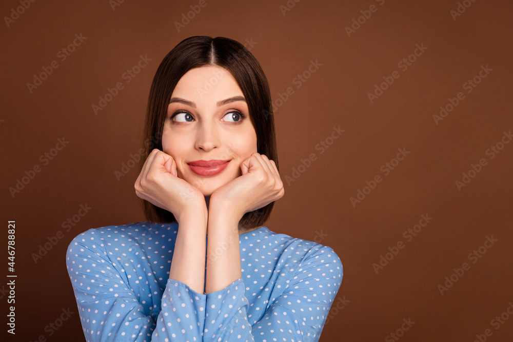 Photo of young woman happy positive smile hands touch chin thoughtful dreamy look empty space isolated over brown color background Photo of young woman happy positive smile hands touch chin thoughtful dreamy look empty space isolated over brown color background