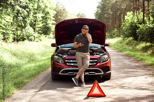 Canvas Print Front view of man using phone for help on the road