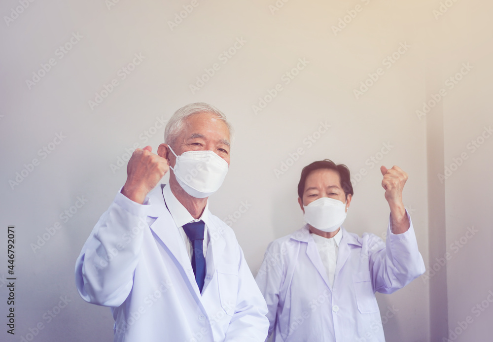 Two Asian senior doctors scientist show successful victory gesture happy results