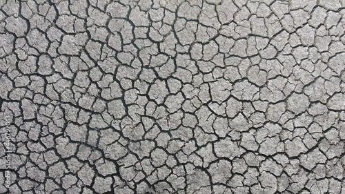 Aerial view takeoff and removal from Cracked crust of soil from drought. Dried crust. Desert without water. Barren field in hot weather.