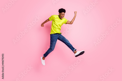 Full body photo of afro american young man jump up air winner good mood isolated on pink color background