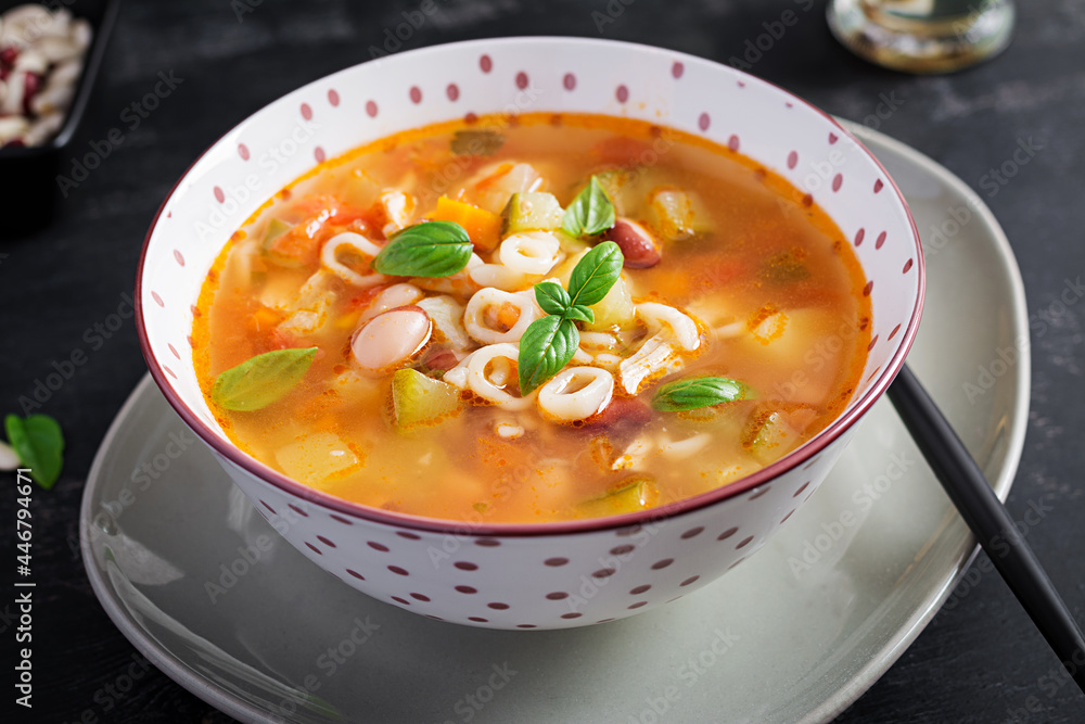 Minestrone, italian vegetable soup with pasta on dark table. Minestrone, italian vegetable soup with pasta on dark table.