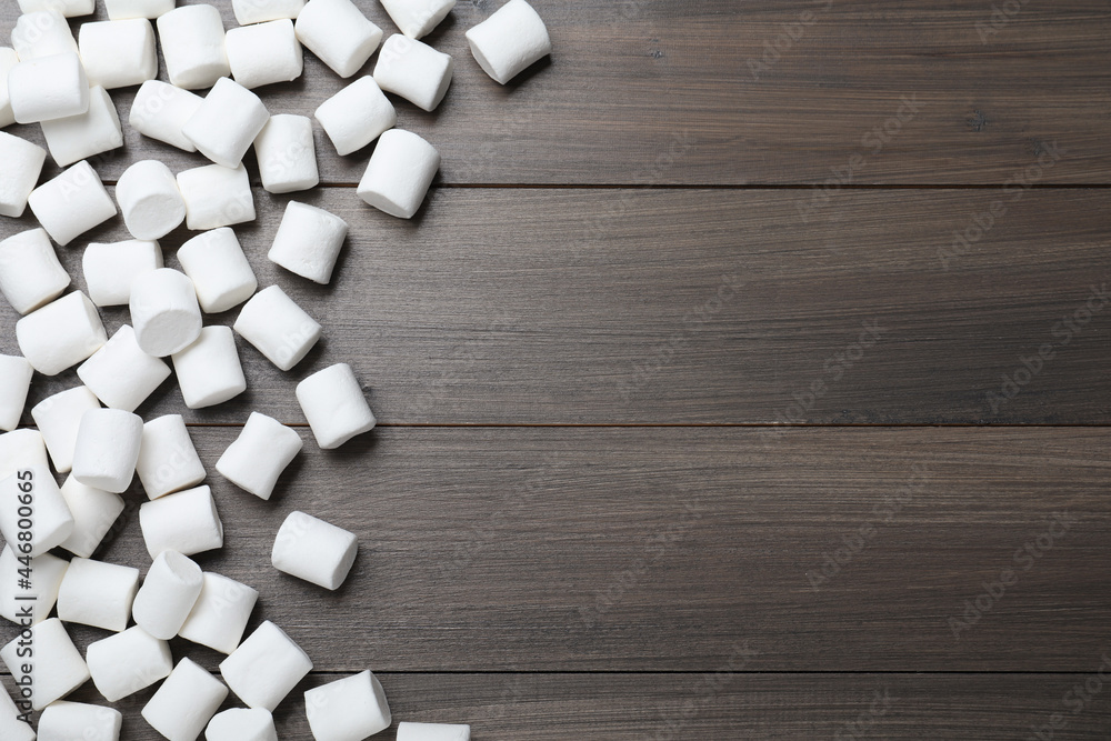 Delicious puffy marshmallows on wooden table, flat lay. Space for text Delicious puffy marshmallows on wooden table, flat lay. Space for text