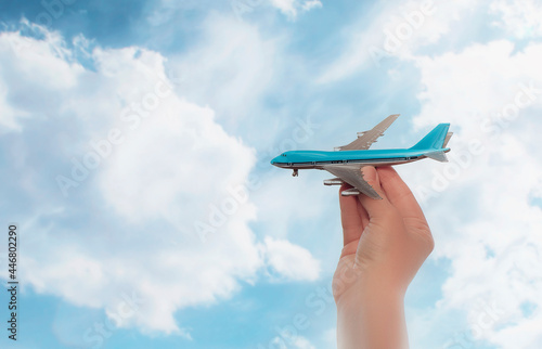 Toy airplane in hand symbol of travel and dreams.