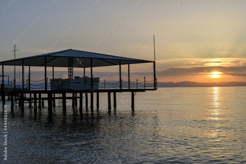 Obraz premium Beautiful scenery with pier on the Mediterranean sea at sunrise. 