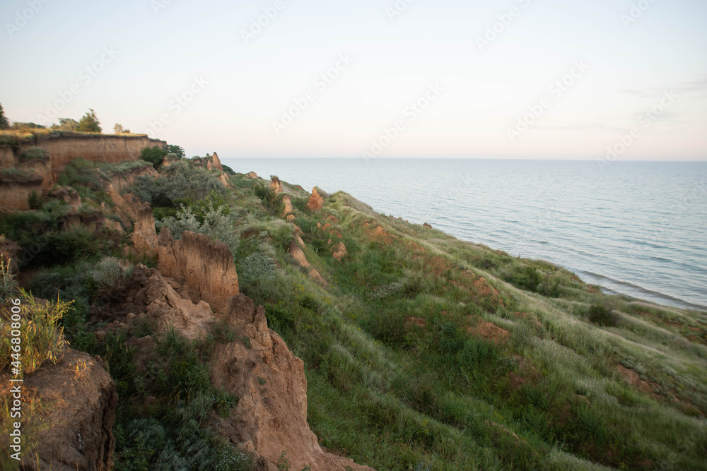 cliff by the sea in the green grass