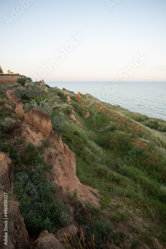 cliff by the sea in the green grass