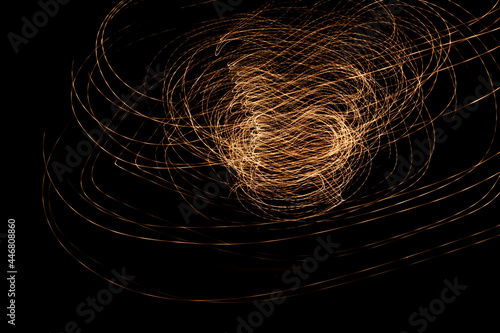 Abstract form of light. Tornado with golden color light. Light painting photo