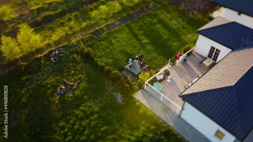 Wallpaper Mural High angle drone shot of a house in small town with green yard where man is making barbecue. Aerial view of a cottage in countryside and male person is frying meat. Spending time in a village on dacha Torontodigital.ca