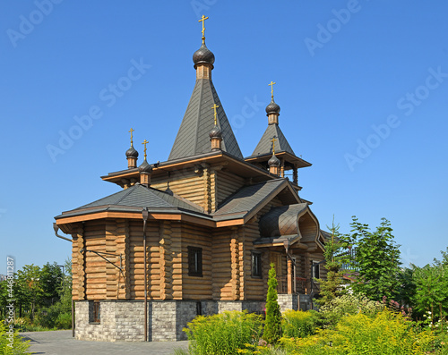 Chapel in Honor of Archangel Gabriel on Khodynka Field in blooming garden. Moscow, Russia