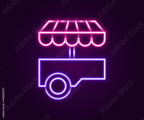 Glowing neon line Fast street food cart with awning icon isolated on black background. Urban kiosk. Colorful outline concept. Vector