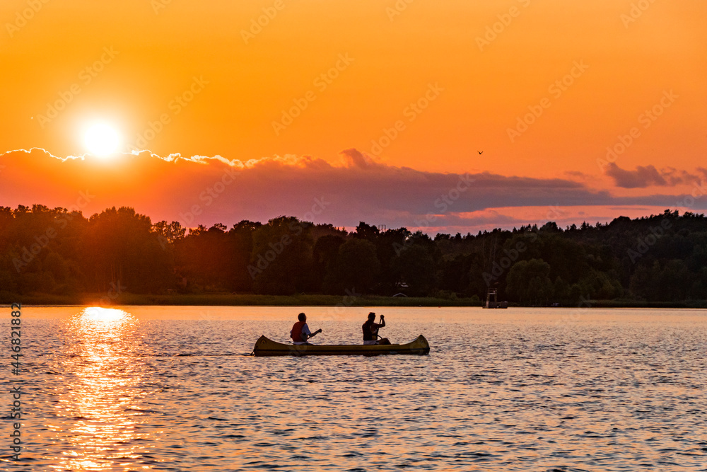 Stockholm, Sweden Canoists in a sunset view over Lake Malaren.