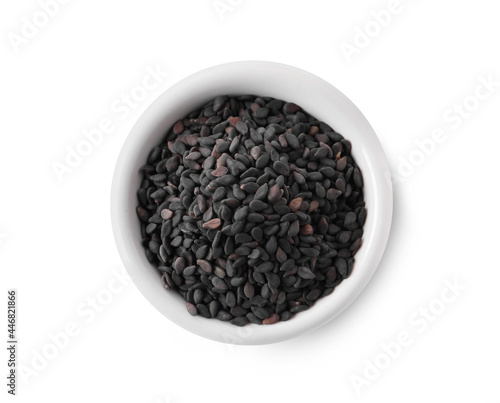 Black sesame seeds with bowl on white background, top view