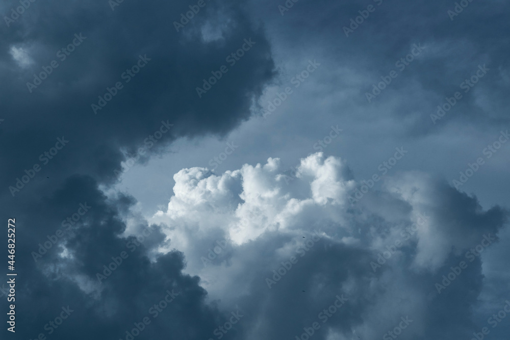 Dark rain clouds hovering in deep blue sky, forming a spectacular cloudscape . Photo taken during monsoon season in Kolkata, West Bengal.