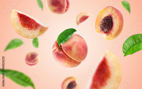 peach slices and leaves flying on peach colour background