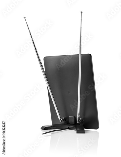 Back view of rectangular black uhf vhf tv antenna with turned off screen on white background with reflection underneath  photo