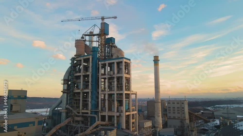 Wallpaper Mural Aerial view of cement plant with high factory structure and tower crane at industrial production area at sunset. Torontodigital.ca