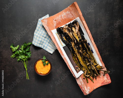 Grilled spring onions with romesco sauce in a cenital view. Spanish cuisine photo