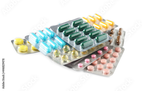 Blisters with different pills on white background