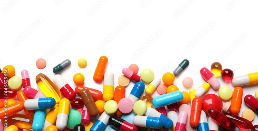 Lots of different colorful pills isolated on white, top view Lots of different colorful pills isolated on white, top view