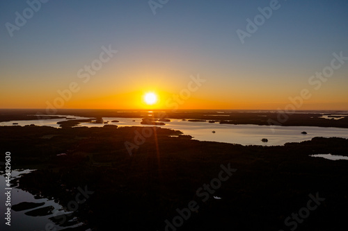 Forested islands in the sea at sunrise. Nature of Scandinavia  Finland. Photo from the drone.