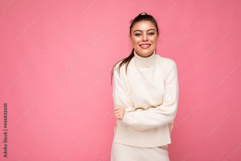 Lovely smiling young woman wearing warm sweater standing isolated over pink background, posing. Positive concept Lovely smiling young woman wearing warm sweater standing isolated over pink background, posing. Positive concept