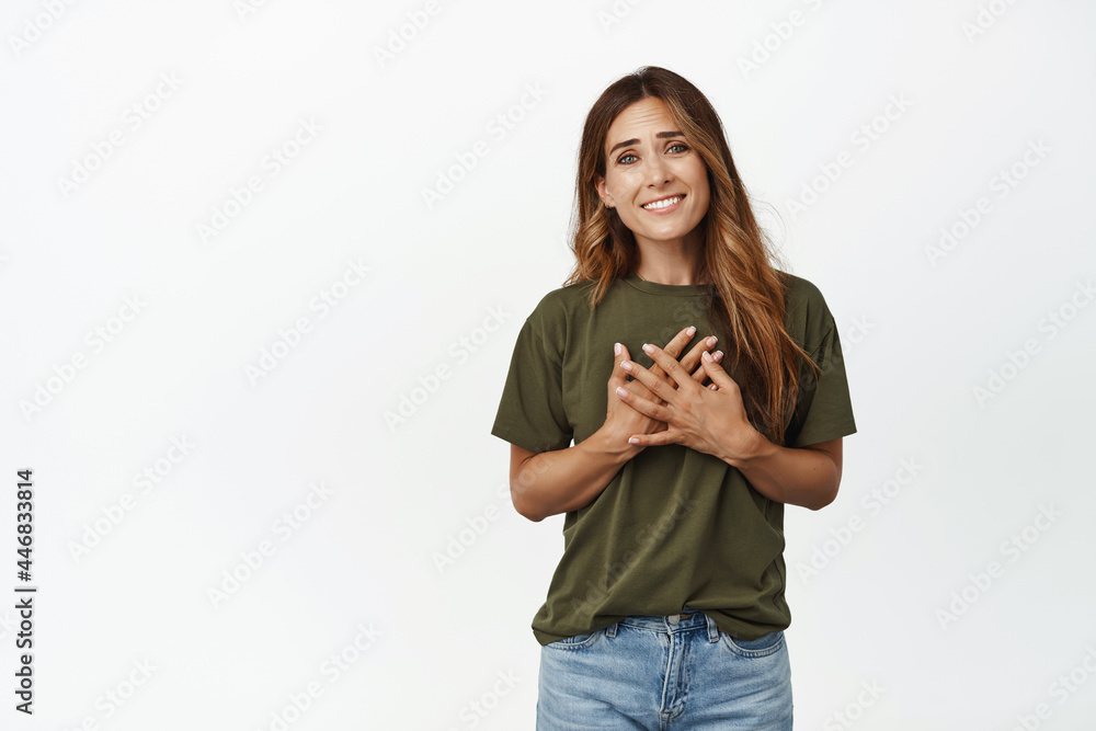 Thank you. Flattered and touched middle aged woman holding hands on chest heart, smiling pleased, grateful for smth, appreciate help, white background Thank you. Flattered and touched middle aged woman holding hands on chest heart, smiling pleased, grateful for smth, appreciate help, white background