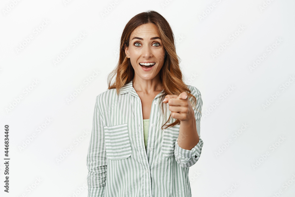 Its you. Surprised and amazed brunette girl pointing finger at camera with face in awe, seeing famous person, impressed by smth, standing against white background Its you. Surprised and amazed brunette girl pointing finger at camera with face in awe, seeing famous person, impressed by smth, standing against white background