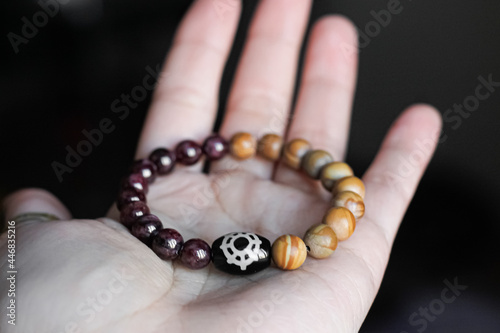 on the human palm is a bracelet made of natural precious stones