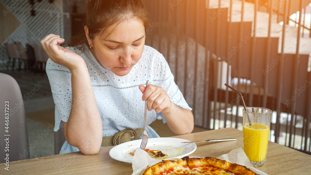 Lady eats pizza enjoying in the restaurant. Lady eats pizza enjoying in the restaurant.