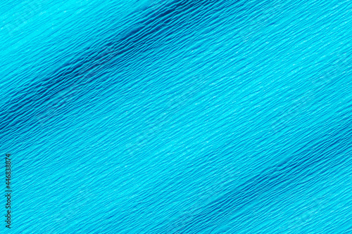 Wrinkled turquoise blue crepe paper background texture