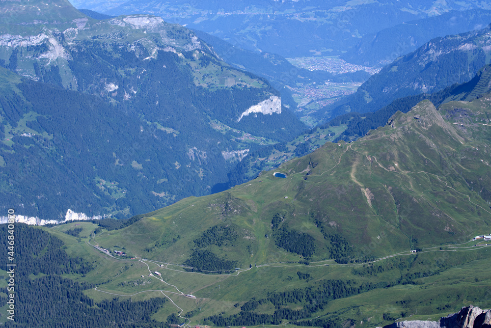 Panoramic view from Jungfraujoch on a beautiful summer day with Village Interlaken in the background. Photo taken July 20th, 2021, Lauterbrunnen, Switzerland. Panoramic view from Jungfraujoch on a beautiful summer day with Village Interlaken in the background. Photo taken July 20th, 2021, Lauterbrunnen, Switzerland.