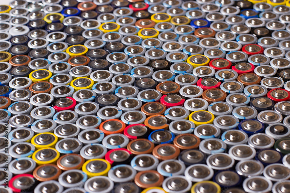 Fototapeta premium used in several rows arranged AAA batteries of different colors and manufacturers