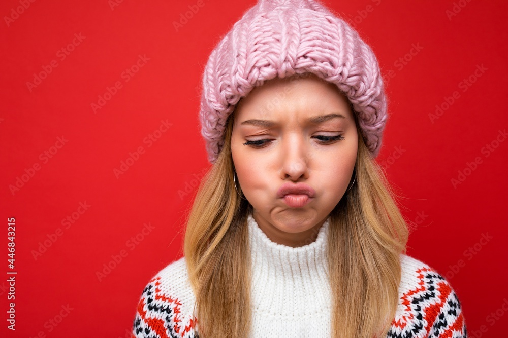 Closeup photo of beautiful amusing sad young blonde woman standing isolated over colourful background wall wearing everyday trendy clothes looking down showing facial emotions Closeup photo of beautiful amusing sad young blonde woman standing isolated over colourful background wall wearing everyday trendy clothes looking down showing facial emotions