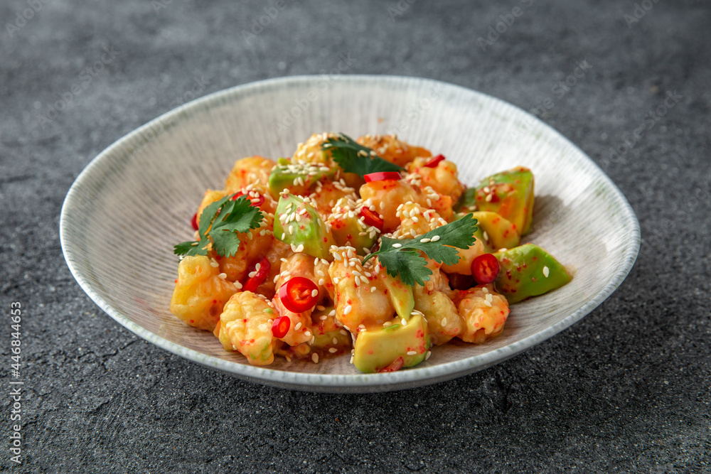 Spicy shrimp stew, zucchini, tomatoes and sauce. Ready menu for the restaurant. Neutral gray blue textured background Spicy shrimp stew, zucchini, tomatoes and sauce. Ready menu for the restaurant. Neutral gray blue textured background