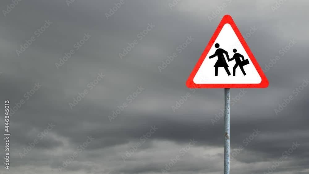 Pedestrian crossing sign board post against dark clouds in the sky Pedestrian crossing sign board post against dark clouds in the sky