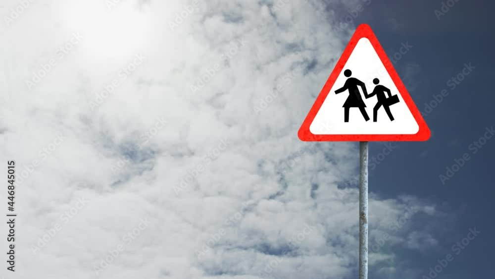Pedestrian crossing sign board post against clouds in the blue sky Pedestrian crossing sign board post against clouds in the blue sky