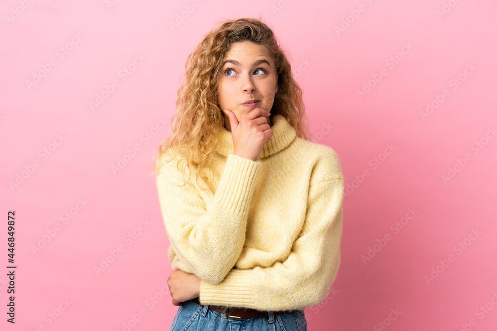 Young blonde woman isolated on pink background thinking an idea while looking up Young blonde woman isolated on pink background thinking an idea while looking up