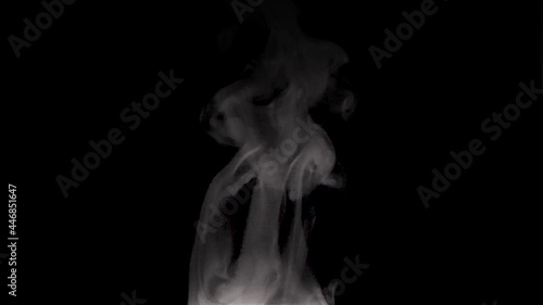 Smoke rises caused by brewing hot coffee poured into a cup.