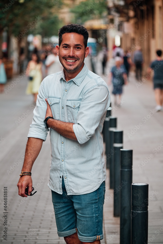 Portrait of a dark-haired Latin boy posing for a photo session on a street in the city of Barcelona.. Portrait of a dark-haired Latin boy posing for a photo session on a street in the city of Barcelona..