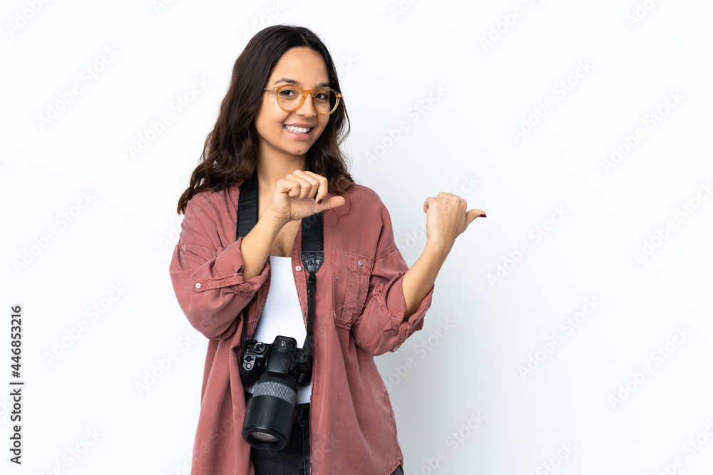 Young photographer woman over isolated white background pointing to the side to present a product Young photographer woman over isolated white background pointing to the side to present a product