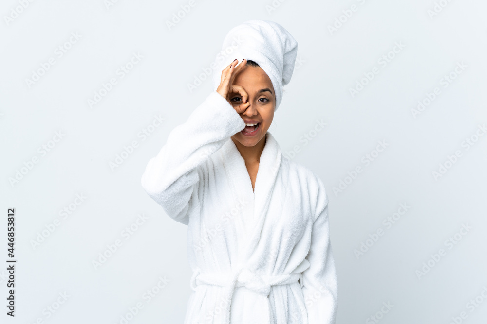 Young woman in bathrobe over isolated white background showing ok sign with fingers Young woman in bathrobe over isolated white background showing ok sign with fingers