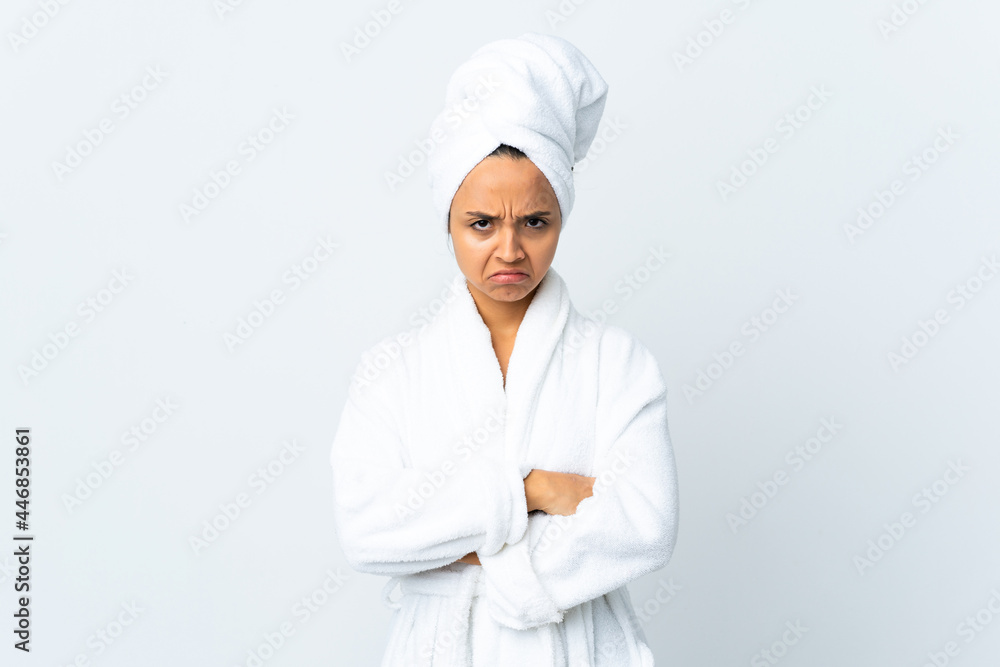 Young woman in bathrobe over isolated white background with unhappy expression