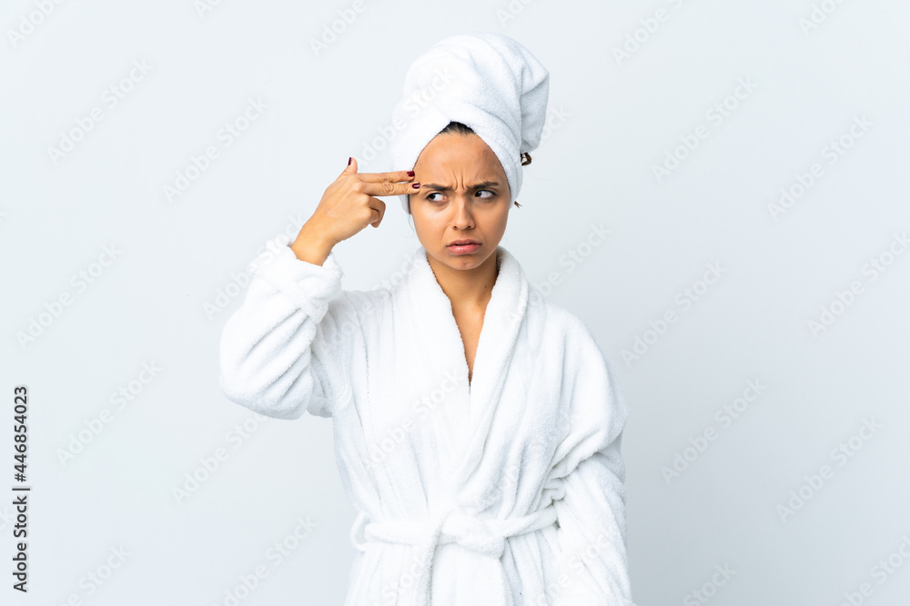 Young woman in bathrobe over isolated white background with problems making suicide gesture Young woman in bathrobe over isolated white background with problems making suicide gesture