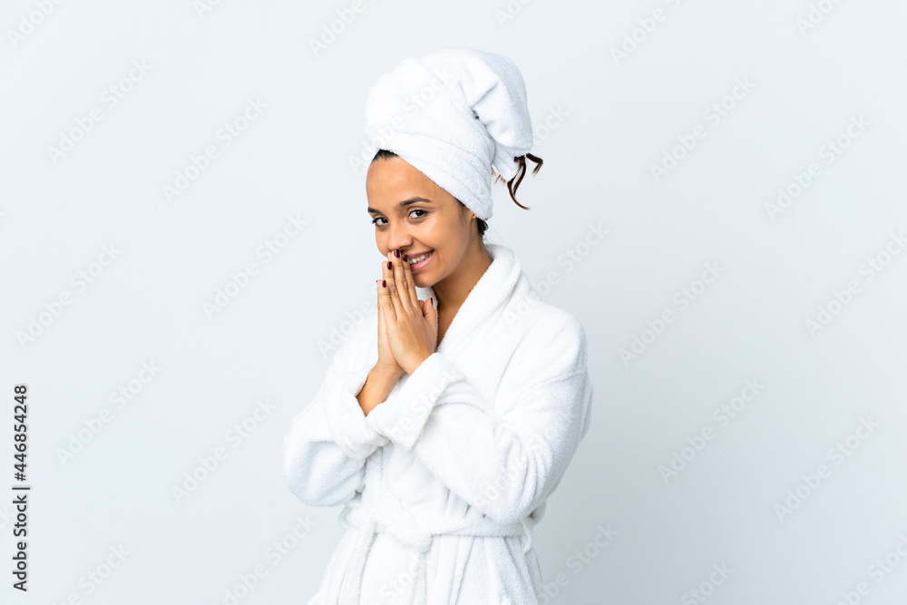 Young woman in bathrobe over isolated white background keeps palm together. Person asks for something Young woman in bathrobe over isolated white background keeps palm together. Person asks for something