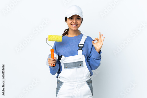 Painter woman over isolated white background showing ok sign with two hands