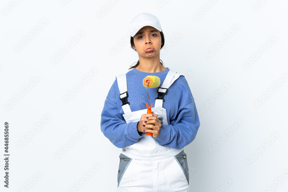 Painter woman over isolated white background keeps palm together. Person asks for something Painter woman over isolated white background keeps palm together. Person asks for something