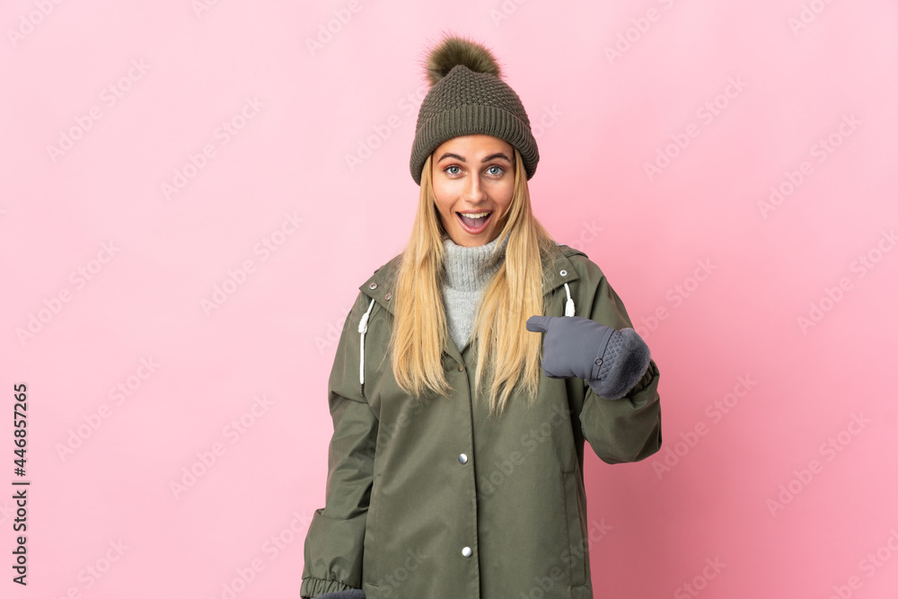 Young woman with winter hat isolated on pink background with surprise facial expression Young woman with winter hat isolated on pink background with surprise facial expression