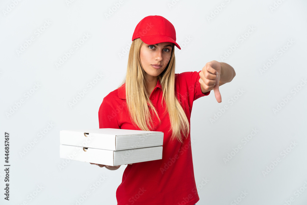 Pizza delivery woman holding a pizza isolated on white background showing thumb down with negative expression Pizza delivery woman holding a pizza isolated on white background showing thumb down with negative expression