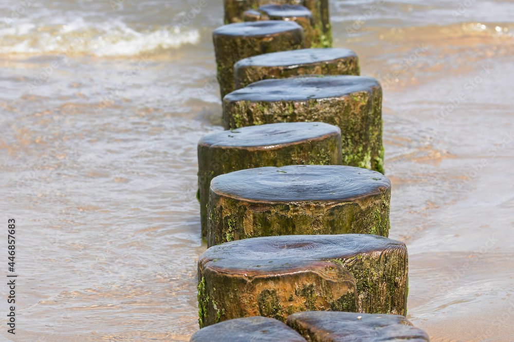 Landscapes of Poland. Breakwater at Baltic sea. Wavy water.